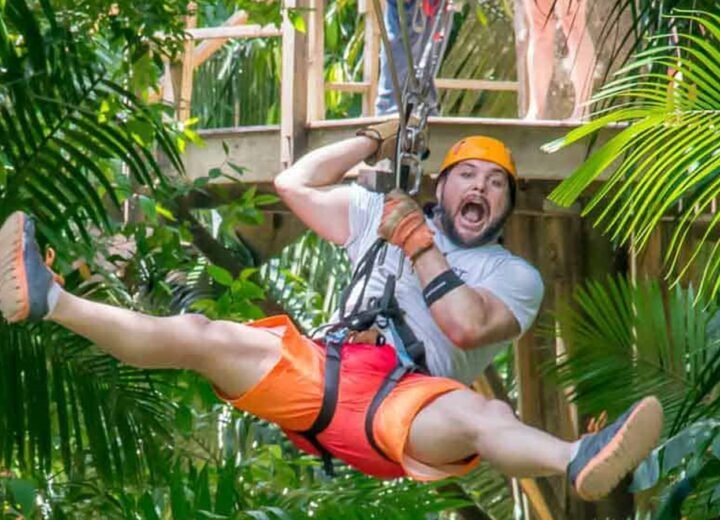 Guest ziplining through the Belize rainforest